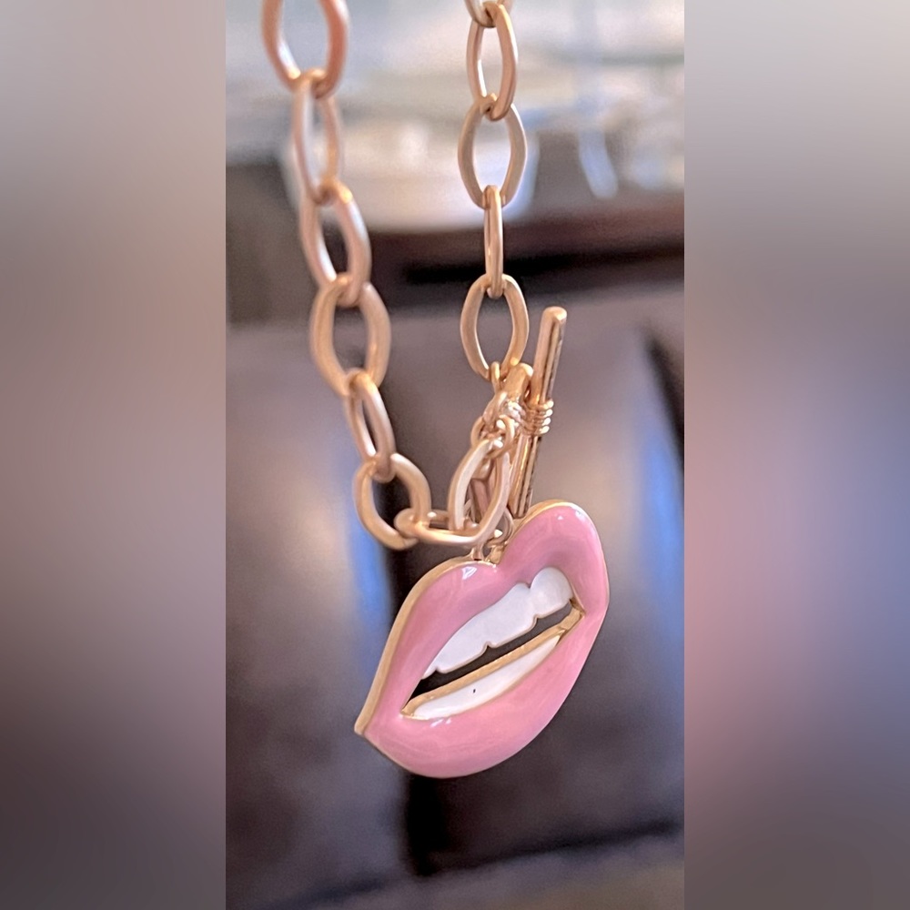 Gold tone chain with pink lip necklace